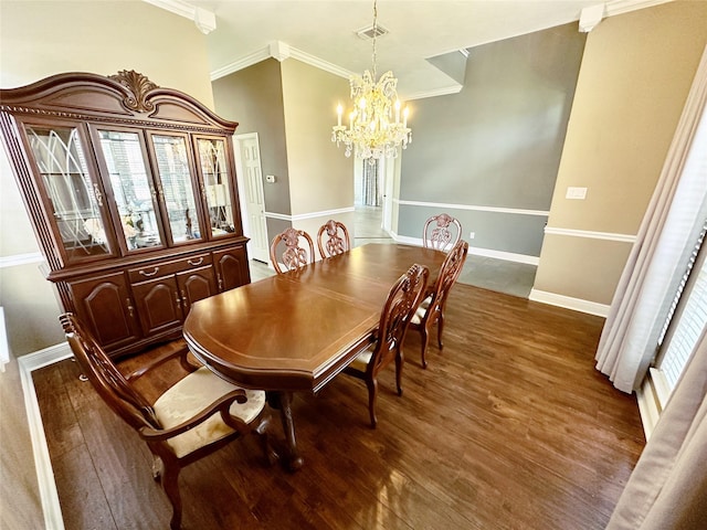 dining area with crown molding, a notable chandelier, wood finished floors, and baseboards