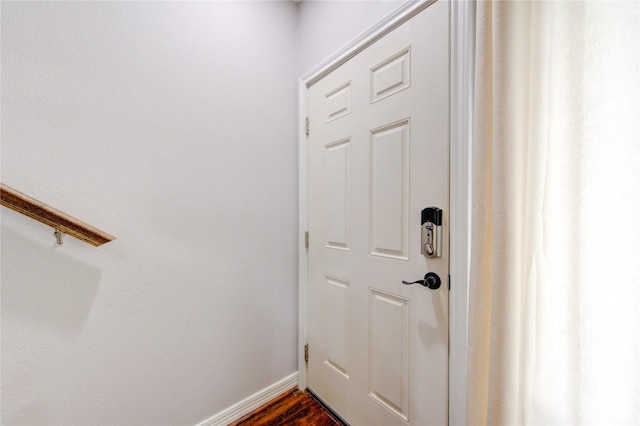 doorway to outside with baseboards and dark wood finished floors