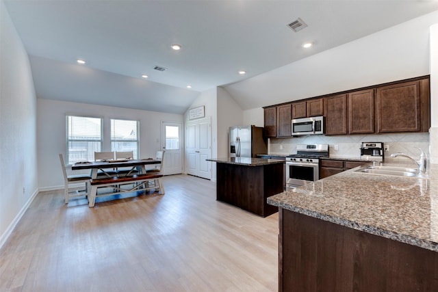 4930 Eldorado Rose Pl, Katy, TX 77493 - kitchen with visible vents, a center island, a sink, stainless steel appliances, and lofted ceiling