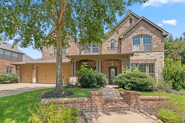 traditional-style house featuring brick siding, an attached garage, and concrete driveway