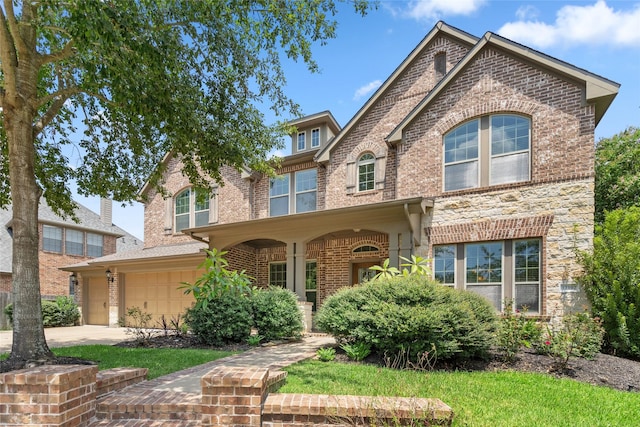 view of front of home with a garage, brick siding, and concrete driveway