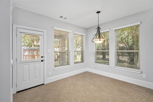 unfurnished dining area featuring visible vents and baseboards