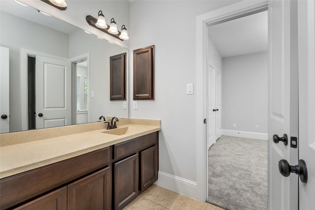 bathroom with vanity and baseboards