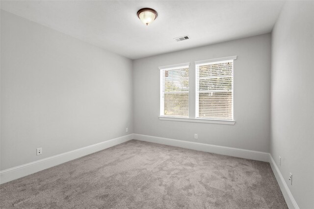 spare room with carpet floors and baseboards