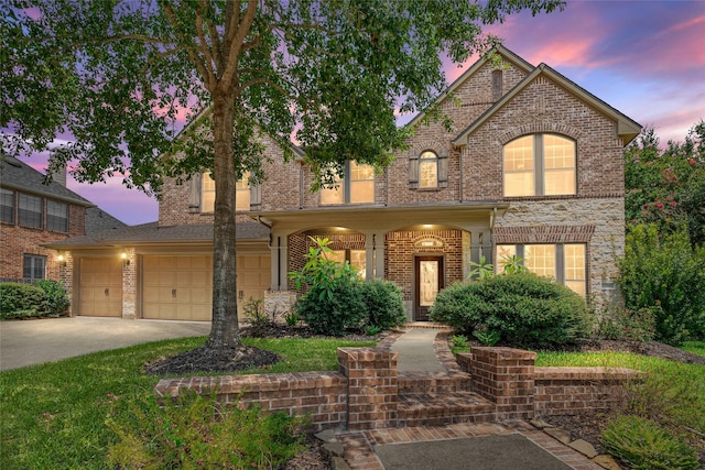 traditional-style home with concrete driveway, brick siding, and an attached garage
