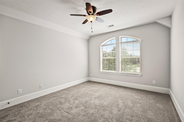carpeted empty room with visible vents, ceiling fan, and baseboards