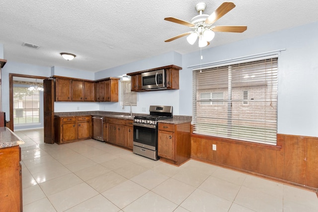 800 Fairway Dr, Richmond, TX 77469 - kitchen featuring visible vents, brown cabinets, ceiling fan, stainless steel appliances, and a sink