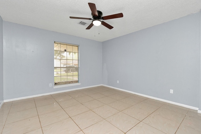 800 Fairway Dr, Richmond, TX 77469 - spare room with baseboards, light tile patterned floors, a textured ceiling, a ceiling fan, and visible vents