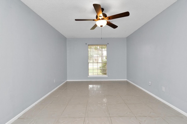 800 Fairway Dr, Richmond, TX 77469 - spare room featuring ceiling fan, light tile patterned flooring, baseboards, and a textured ceiling