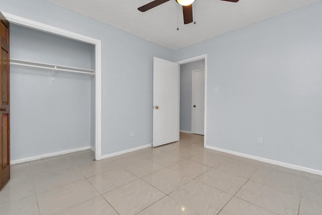 800 Fairway Dr, Richmond, TX 77469 - unfurnished bedroom with ceiling fan, light tile patterned floors, a textured ceiling, a closet, and baseboards