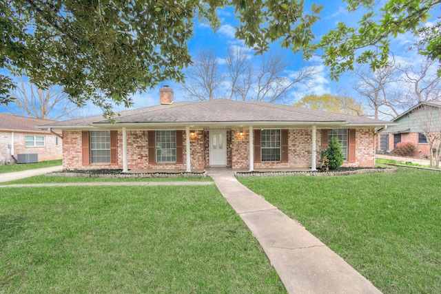 800 Fairway Dr, Richmond, TX 77469 - ranch-style house with brick siding, a chimney, a front lawn, and central air condition unit