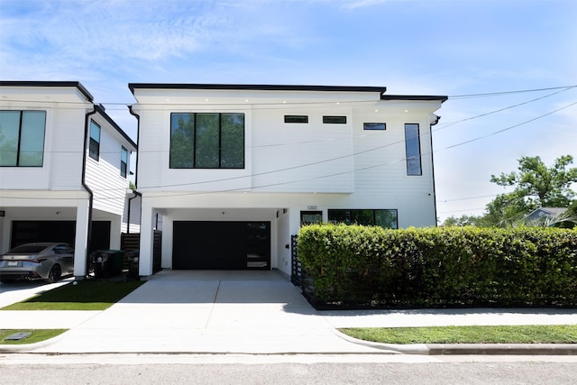 view of front facade with a carport, an attached garage, and driveway
