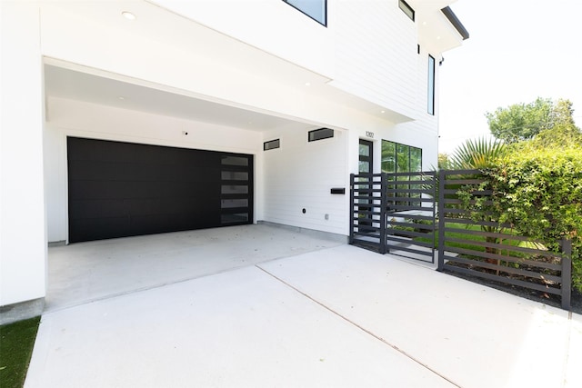 view of home's exterior with a garage and concrete driveway