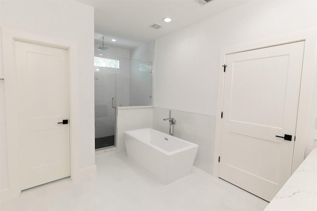 bathroom featuring recessed lighting, a stall shower, visible vents, and a soaking tub
