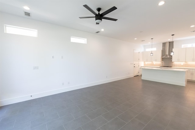 unfurnished living room featuring a ceiling fan, recessed lighting, baseboards, and visible vents