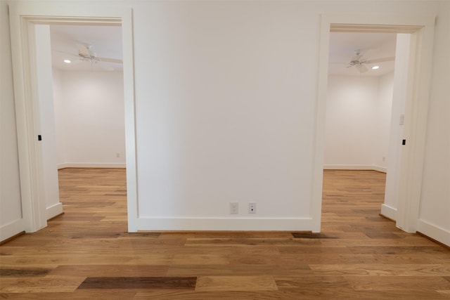 interior space featuring light wood-type flooring, a ceiling fan, baseboards, and recessed lighting