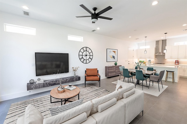 living room featuring tile patterned floors, visible vents, ceiling fan, and recessed lighting