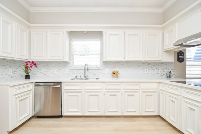 kitchen featuring plenty of natural light, dishwasher, light countertops, and a sink