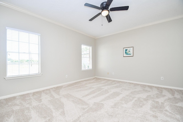 unfurnished room with crown molding, baseboards, a ceiling fan, and light colored carpet