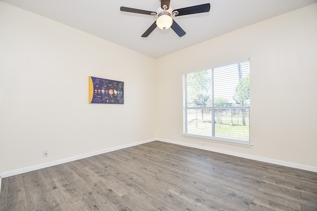 empty room featuring baseboards, a ceiling fan, and wood finished floors