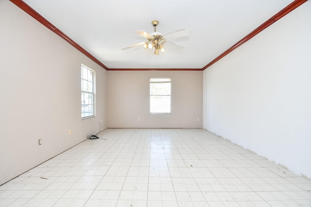 empty room with ornamental molding, a ceiling fan, and a healthy amount of sunlight