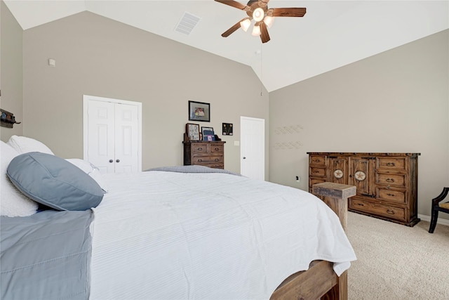 bedroom with a closet, light carpet, visible vents, a ceiling fan, and high vaulted ceiling