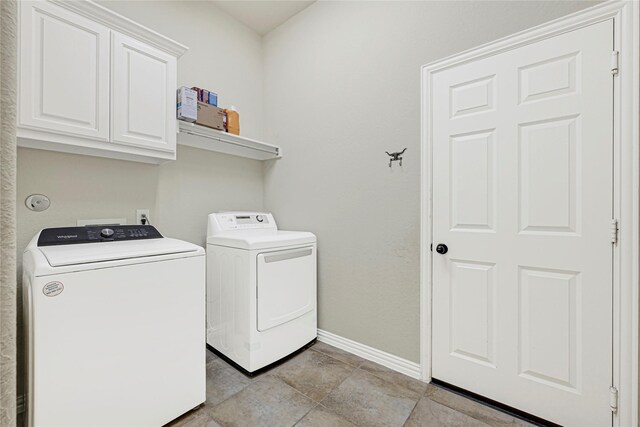 laundry room with cabinet space, washing machine and clothes dryer, and baseboards