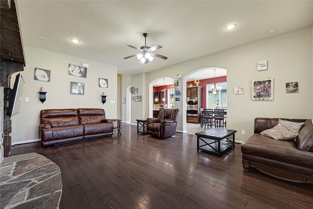 living area with recessed lighting, arched walkways, ceiling fan, and hardwood / wood-style flooring