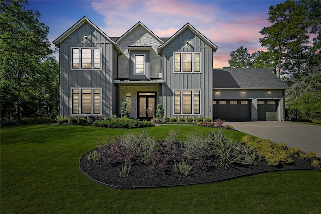 513 Pineal Dr, Montgomery, TX 77316 - modern farmhouse with board and batten siding, an attached garage, a front lawn, and driveway