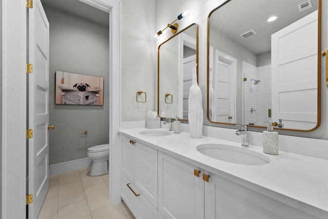 513 Pineal Dr, Montgomery, TX 77316 - full bathroom featuring double vanity, tile patterned flooring, a shower stall, toilet, and baseboards
