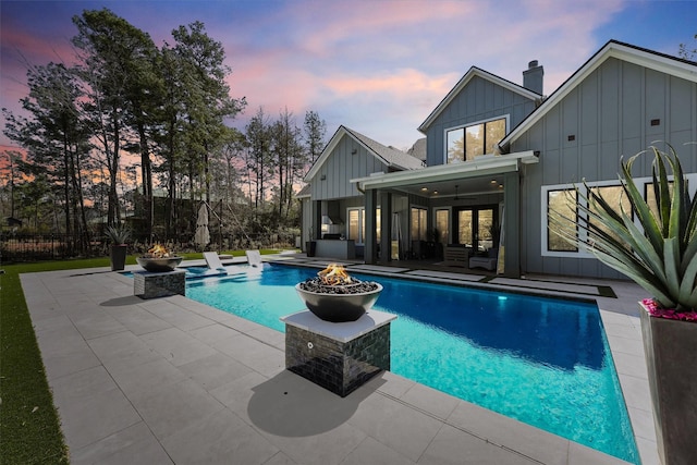 513 Pineal Dr, Montgomery, TX 77316 - pool at dusk with a patio, an outdoor living space with a fire pit, and ceiling fan