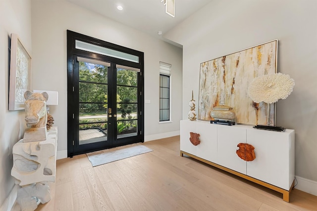 513 Pineal Dr, Montgomery, TX 77316 - foyer with french doors, wood finished floors, and baseboards