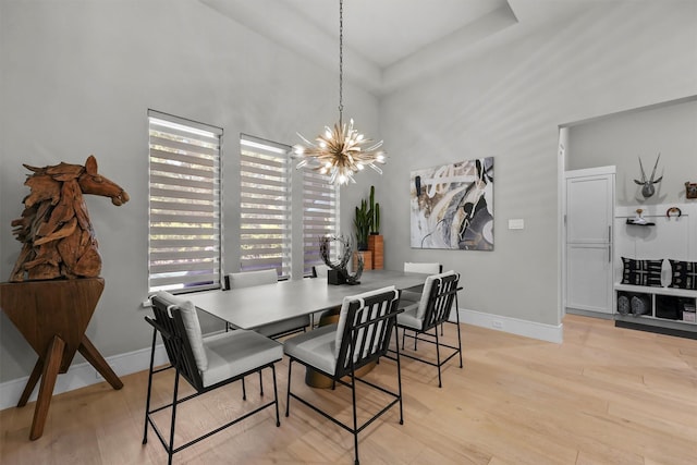 513 Pineal Dr, Montgomery, TX 77316 - dining area with a chandelier, wood finished floors, baseboards, and a high ceiling