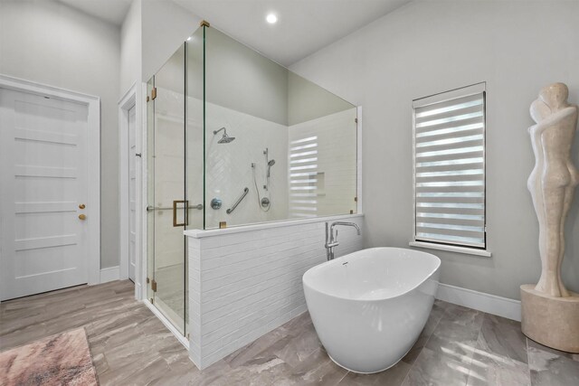 513 Pineal Dr, Montgomery, TX 77316 - full bath featuring a stall shower, healthy amount of natural light, a freestanding bath, baseboards, and recessed lighting