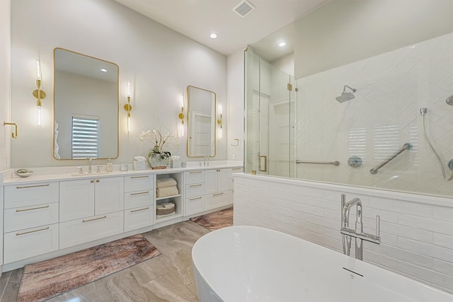 513 Pineal Dr, Montgomery, TX 77316 - full bath featuring a freestanding tub, double vanity, a tile shower, marble finish flooring, and recessed lighting