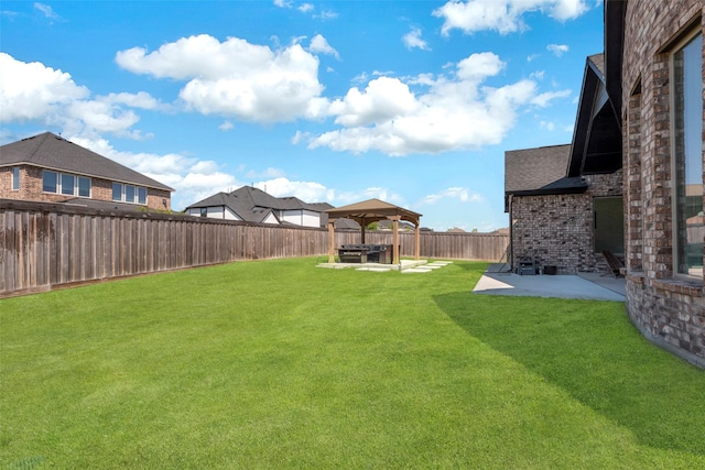 view of yard featuring a gazebo, a patio area, and a fenced backyard