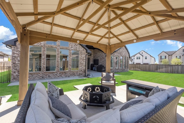view of patio with a fenced backyard and an outdoor living space with a fire pit