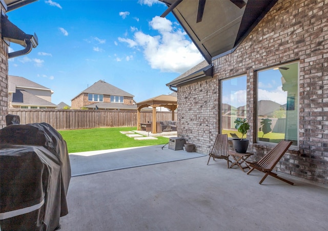 view of patio featuring a fenced backyard, a gazebo, and area for grilling
