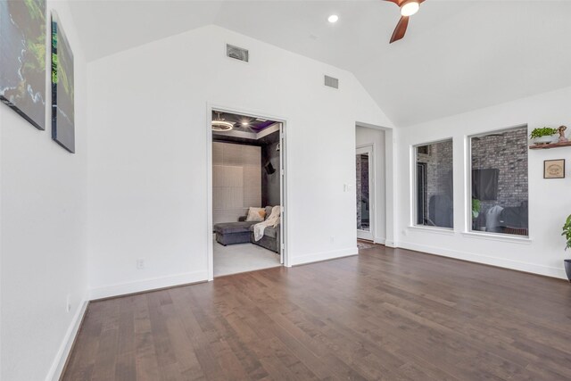 unfurnished room featuring baseboards, visible vents, lofted ceiling, a ceiling fan, and wood finished floors