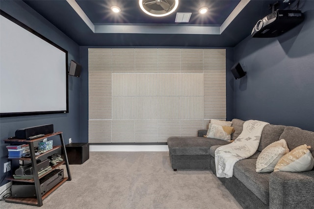 carpeted cinema featuring a tray ceiling and recessed lighting