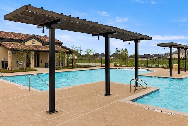 pool with a pergola, a patio area, and fence