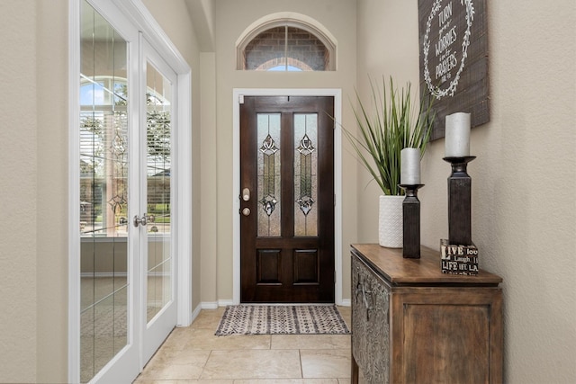 19122 Panther Cave Ct, Cypress, TX 77433 - foyer entrance with french doors, light tile patterned floors, baseboards, and plenty of natural light