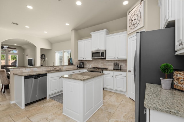 19122 Panther Cave Ct, Cypress, TX 77433 - kitchen featuring a peninsula, visible vents, a sink, stainless steel appliances, and decorative backsplash