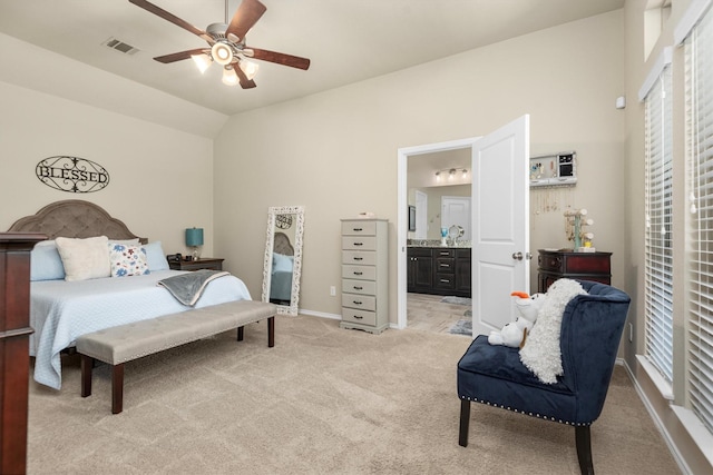 19122 Panther Cave Ct, Cypress, TX 77433 - bedroom with visible vents, baseboards, ensuite bathroom, light carpet, and lofted ceiling
