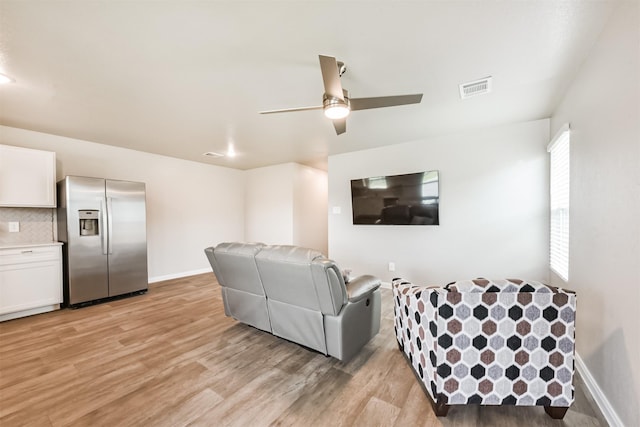 16499 Valerie Marie Pl, Conroe, TX 77306 - living area with baseboards, a ceiling fan, light wood finished floors, and visible vents