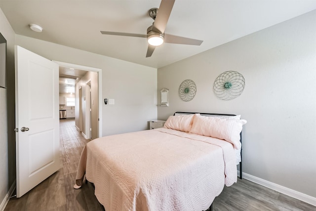 16499 Valerie Marie Pl, Conroe, TX 77306 - bedroom with baseboards, wood finished floors, and ceiling fan