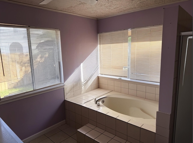 8622 Sparkling Springs Dr, Houston, TX 77095 - full bathroom with baseboards, tile patterned flooring, a garden tub, and a textured ceiling