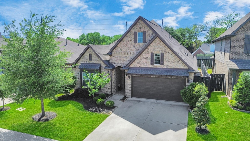 2523 Artichoke Park Dr, Richmond, TX 77406 - view of front of home with a front yard, brick siding, a garage, and concrete driveway