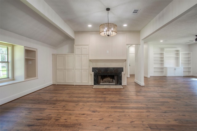83 Dahlia Rd, Huntsville, TX 77320 - unfurnished living room with dark wood-style flooring, visible vents, baseboards, and a premium fireplace