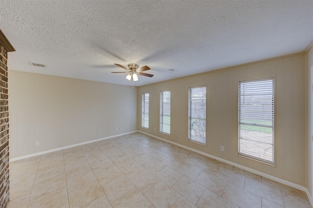 unfurnished room featuring visible vents, baseboards, light tile patterned floors, a ceiling fan, and a textured ceiling